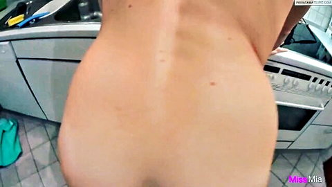 Naked white woman bends over kitchen sink exposing her big round ass cheeks
