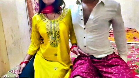 Sexy Indian couple in traditional clothes cuddling intimately on bed teasing foreplay