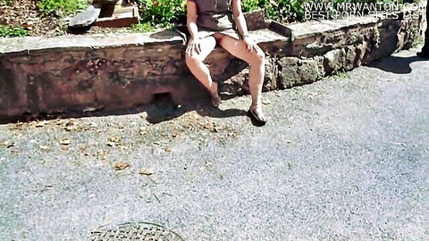 Amateur woman in unbuttoned dress flashes shaved pussy outdoors