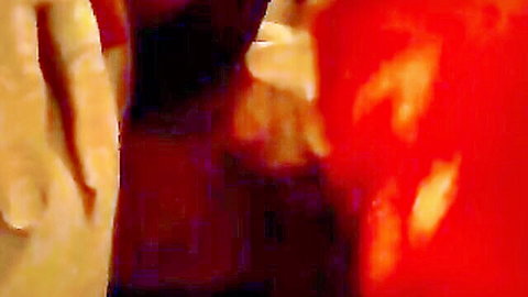 Blurry hands gripping red object in amateur wife porn video