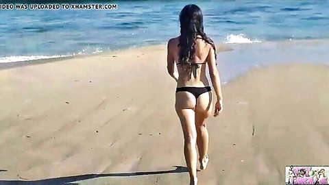 Foxy Caroline in sexy black bikini, walking on beach showing round ass