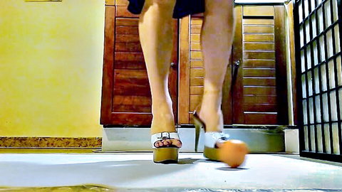 Sexy waitress in platform heels crushing orange fetish play