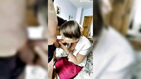 Mature woman in white blouse red skirt giving blowjob to man on bed