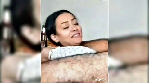 Arab woman moaning in orgasmic ecstasy with eyes closed as hairy man embraces her tightly