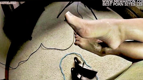 Closeup of woman's bare pale foot soles and toes displayed teasingly for foot worship fetish