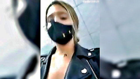 Masked blonde bombshell flashes deep cleavage in open leather jacket on public bus