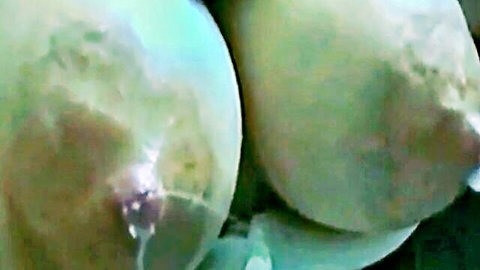 Close-up of lactating big tits squirting milk