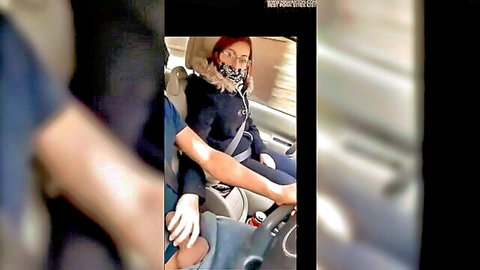 Redhead hitchhiker with glasses and mask in car, fur coat, driver hand on thigh