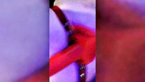 Woman in white harness bending over with red strap-on dildo ready