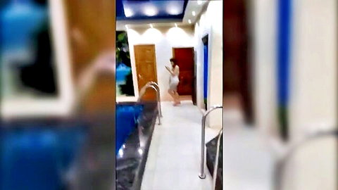 Ukrainian girl in white dress walking by pool in Murat's adventure