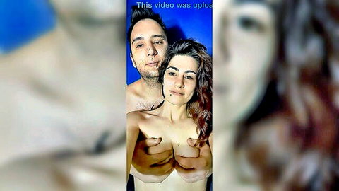 Italian couple in topless embrace, man groping woman's perky breasts