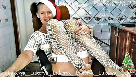 Lukerya in festive white fishnet lingerie and Santa hat, seductive pose