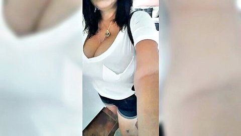 Sexy mature grandma in white tank top and shorts showing deep cleavage