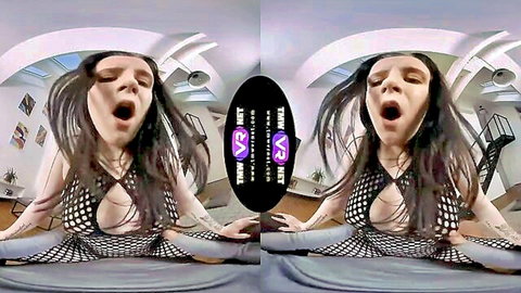 Caroline Mann in black fishnet dress, moaning with legs spread, VR porn