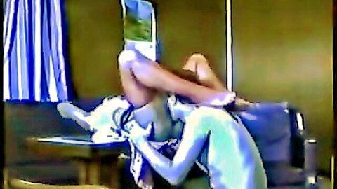 Blue painted man performs cunnilingus on spread-legs woman's exposed pussy in white stockings on table