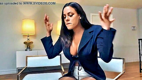 Tanned curvy Latina MILF in open blazer showing massive cleavage raises hands teasingly