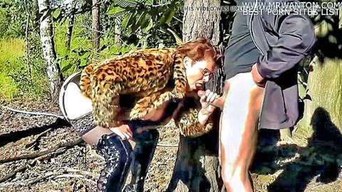Mature redhead in leopard fur coat gives outdoor forest blowjob to stranger's hard cock