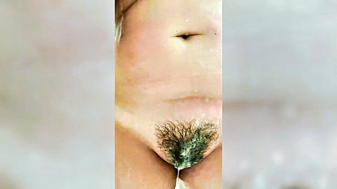Close-up of wet blonde woman's pubic area in shower