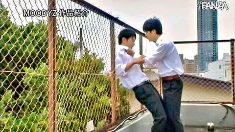 Two Japanese schoolboys in uniforms wrestling playfully on rooftop JAV scene