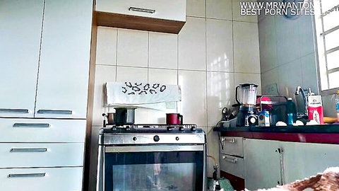 Bright housewife kitchen with white cabinets gas stove blender and milk carton on counter