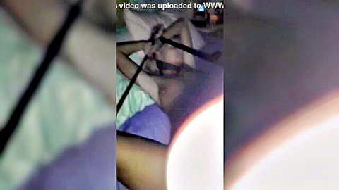 Bound slim Asian woman with toy insertion in explicit pose