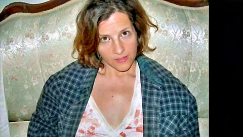 Seductive brunette woman in open plaid jacket showing lace cleavage