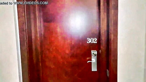 Medusa at hotel room 302 door in Black Santa gift video