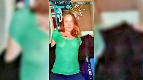 Redhead in sheer green top teases with brief striptease
