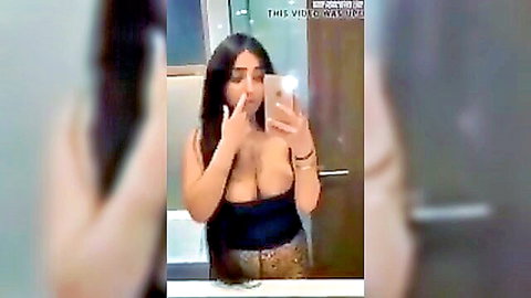Sexy Arab beauty with massive cleavage in low-cut top, mirror selfie tease