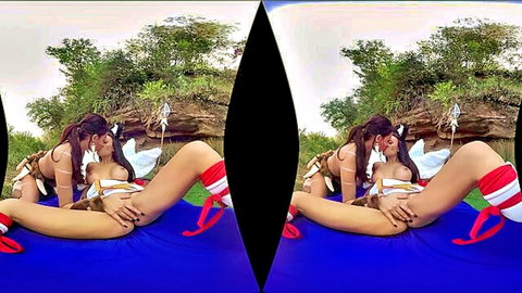 Two busty Asian cosplay babes in tribal outfits kiss passionately while fingering outdoors