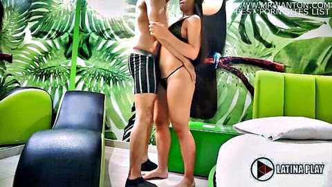 Latina babe with big ass in black thong embraces muscular guy in tropical hotel room
