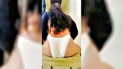 Curvy brunette in white thong panties bends over yellow chair exposing plump ass cheeks from behind