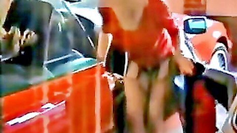 Secretary Gisela undressing by red car in garage