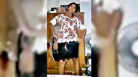 South Asian woman in floral blouse and short skirt posing hands on hips