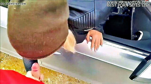 Blonde in beanie teases hard cock with foot through car window outdoors