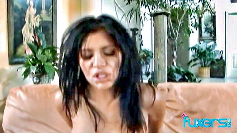 Brunette MILF with medium tits exposed sitting topless on couch moaning in ecstasy