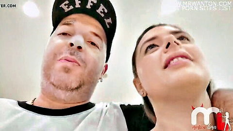 Tattooed man in cap and busty Latina gazing up passionately mouths open in intense rough sex POV