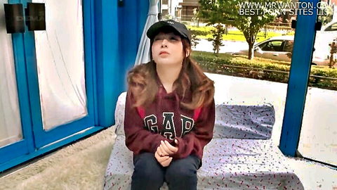 Cute Asian girl in red hoodie and cap, seductive outdoor pose