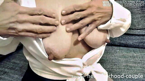 Asian woman exposes breasts in open white shirt, hands groping in CFNM tease