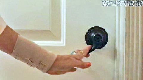 Love, Mommy: Woman's hand in wrist brace turning doorknob teasingly
