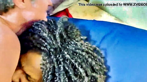 Ebony mature woman with curly hair kissed intimately by light-skinned stranger