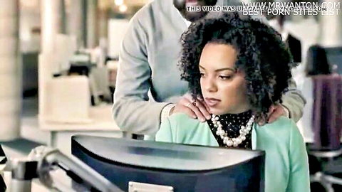 Ebony woman in green top gets intimate shoulder massage from man in office setting