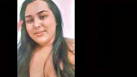 Curvy Latina with long dark hair, big breasts, smiling topless