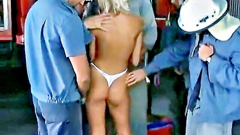 Mona Bella topless in white thong, groped by firemen from behind