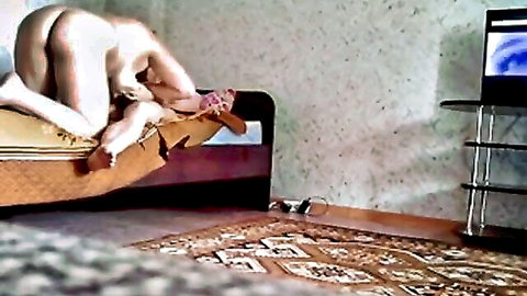 Nude pale woman bent over bed exposing shaved pussy and tight ass cheeks from behind