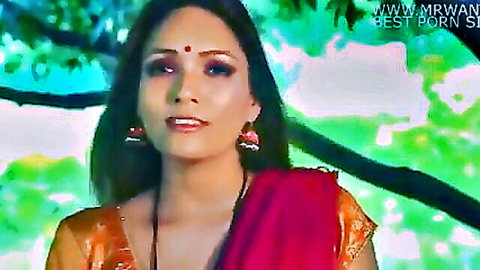 Indian beauty in red saree smiling seductively outdoors