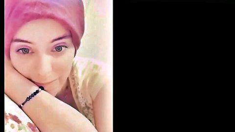 Smiling Turkish hijab girl in pink scarf with bracelet resting cheek on hand teasing