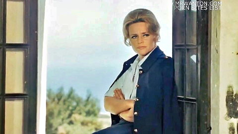 Blonde woman in navy uniform arms crossed in seaside doorway
