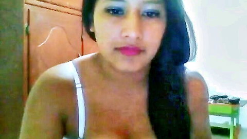 Sexy Latina with huge tits spilling from white bra in sensual bedroom selfie