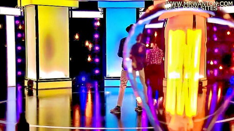Clothed men walking on vibrant neon-lit stage during mrwantons.com premier sites live show